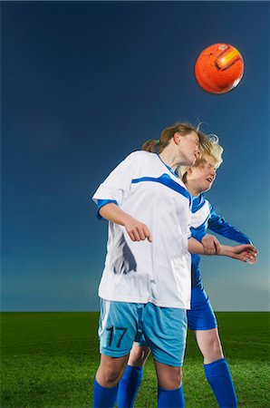 simsearch:649-07239531,k - Female footballers heading the ball Stock Photo - Premium Royalty-Free, Code: 649-07239525
