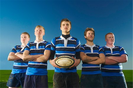 rugby players - Portrait of rugby team, one man holding ball Stock Photo - Premium Royalty-Free, Code: 649-07239527