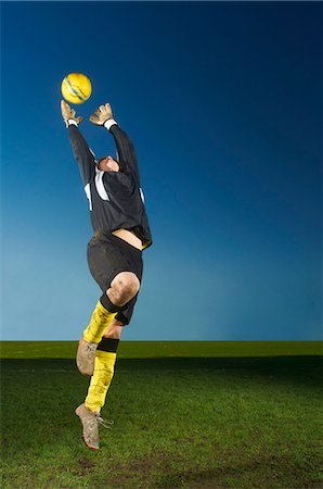 simsearch:649-07239531,k - Goalkeeper jumping to catch football Stock Photo - Premium Royalty-Free, Code: 649-07239538