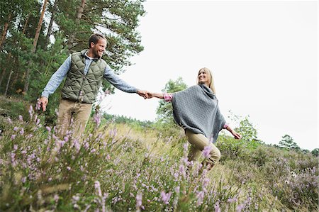 poncho - Mid adult couple holding hands in meadow Stock Photo - Premium Royalty-Free, Code: 649-07239752
