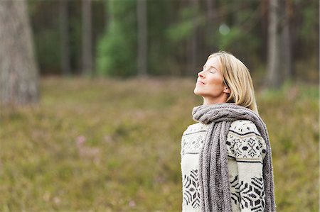 escapism - Mid adult woman wearing sweater with eyes closed Stock Photo - Premium Royalty-Free, Code: 649-07239773