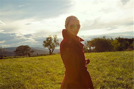 fashion portrait - Young woman in field posing in sunglasses Stock Photo - Premium Royalty-Free, Code: 649-07239856