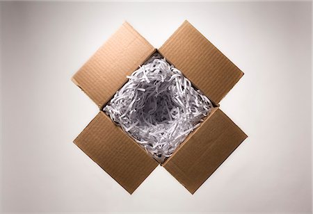 Still life with open cardboard box and shredded paper Stock Photo - Premium Royalty-Free, Code: 649-07239861