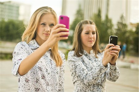 simsearch:649-07736862,k - Two young women taking self portraits on mobile phone Stock Photo - Premium Royalty-Free, Code: 649-07239889