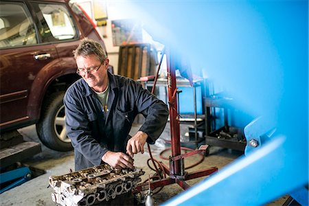 Mechanic working on car parts in garage Stock Photo - Premium Royalty-Free, Code: 649-07239905