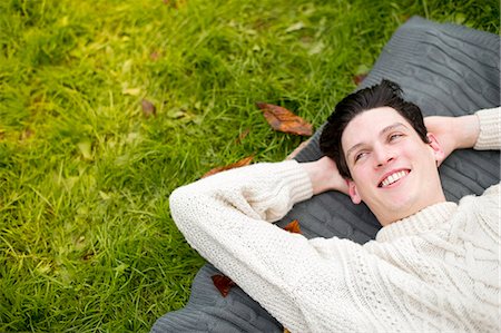 simsearch:649-07279678,k - Young man lying on rug wearing sweater Stock Photo - Premium Royalty-Free, Code: 649-07279640