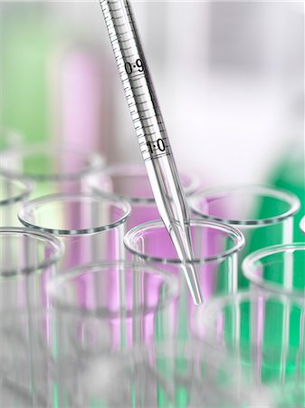 A graduated pipette being inserted into test tube Stock Photo - Premium Royalty-Free, Code: 649-07279796