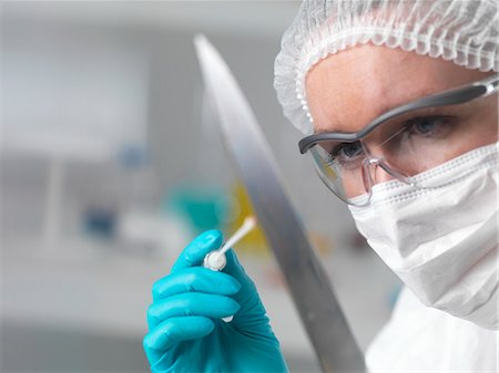 scene of a crime - Forensic scientist in laboratory taking DNA evidence with a swab for crime investigation Stock Photo - Premium Royalty-Free, Code: 649-07279843
