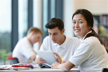 school girl uniforms - Teenagers working in school classroom Foto de stock - Sin royalties Premium, Código: 649-07280078