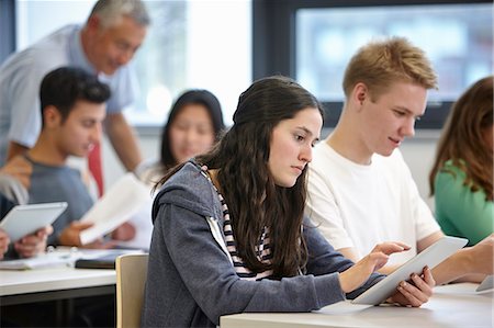 school desk - Teenagers working with digital tablets classroom Stock Photo - Premium Royalty-Free, Code: 649-07280091