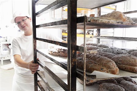 Baker pulling trolley of bread Stock Photo - Premium Royalty-Free, Code: 649-07280444