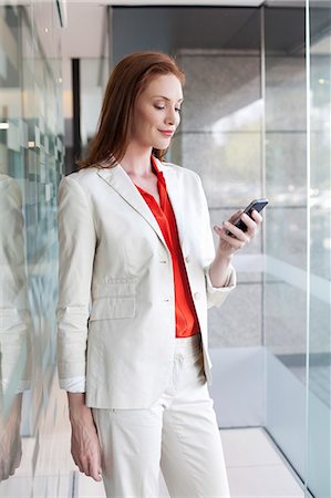 pantsuit - Businesswoman using smartphone Stock Photo - Premium Royalty-Free, Code: 649-07280660