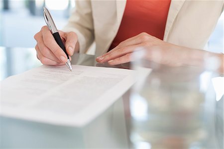 Cropped image of businesswoman signing paperwork Stock Photo - Premium Royalty-Free, Code: 649-07280677