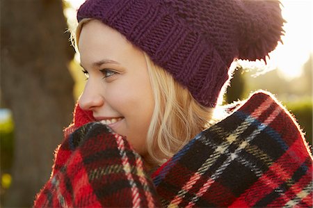 simsearch:649-07280729,k - Portrait of young woman in park, tartan picnic blanket around shoulders Stock Photo - Premium Royalty-Free, Code: 649-07280749
