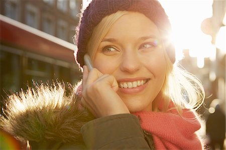 simsearch:649-07280729,k - Portrait of young woman wearing knit hat, telephone call Stock Photo - Premium Royalty-Free, Code: 649-07280741