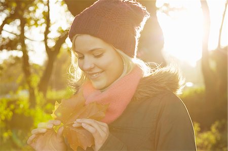 simsearch:649-07280729,k - Portrait of young woman in park, holding autumn leaf Stock Photo - Premium Royalty-Free, Code: 649-07280743