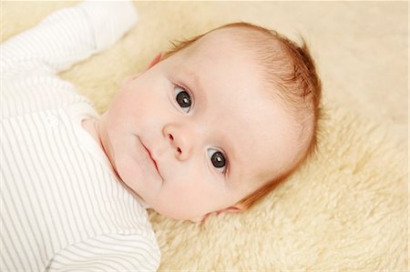 Two month old baby boy lying on furry blanket Stock Photo - Premium Royalty-Free, Code: 649-07280772