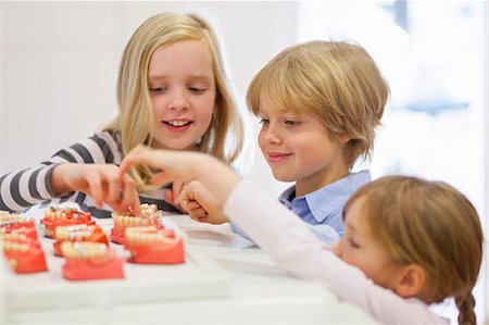 dentures - Children looking at false teeth Stock Photo - Premium Royalty-Free, Code: 649-07280841