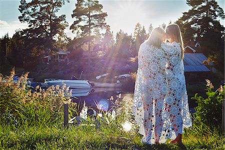 simsearch:614-05557077,k - Two young adult female friends wrapped in blanket, Gavle, Sweden Stock Photo - Premium Royalty-Free, Code: 649-07280974