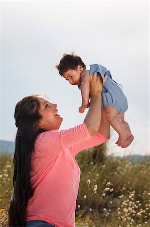 simsearch:649-07436413,k - Mother holding baby in midair Stock Photo - Premium Royalty-Free, Code: 649-07436389