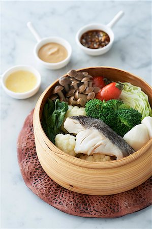 Bamboo steamer of fresh fish and vegetables with condiments Stock Photo - Premium Royalty-Free, Code: 649-07436457