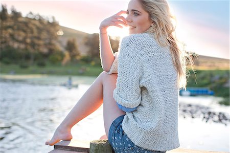 Young woman sitting on pier Stock Photo - Premium Royalty-Free, Code: 649-07436562