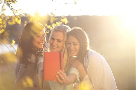 Three young women taking self portrait in park Stock Photo - Premium Royalty-Free, Code: 649-07436585