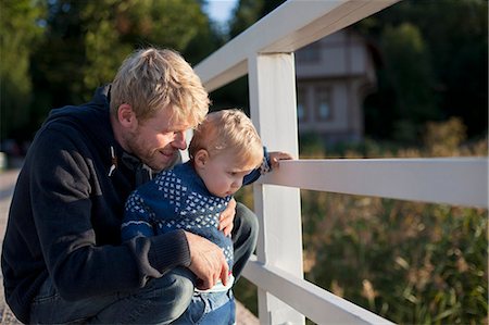 simsearch:649-07437107,k - Father and toddler son looking through railing Stock Photo - Premium Royalty-Free, Code: 649-07437108
