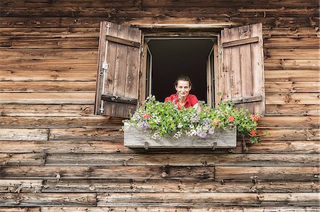 pictures of windows with plants - Portrait of mid adult woman at chalet window, Achenkirch,  Tyrol, Austria Stock Photo - Premium Royalty-Free, Code: 649-07437139