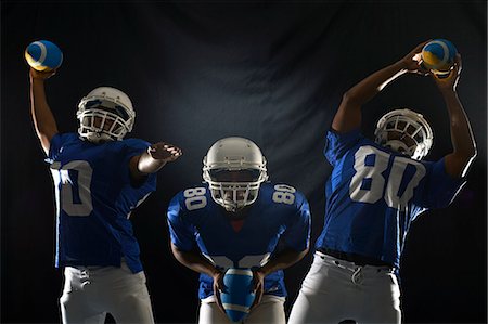 football player action not soccer - Studio composite shot of american footballer reaching for ball Stock Photo - Premium Royalty-Free, Code: 649-07437164