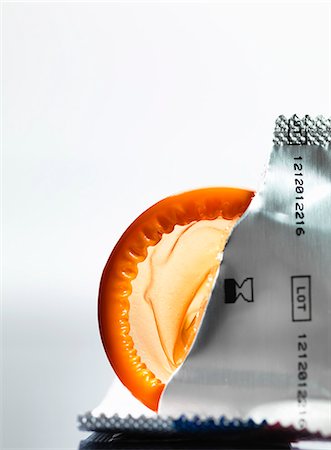 Torn packaging of wrapper containing a condom Stock Photo - Premium Royalty-Free, Code: 649-07437302