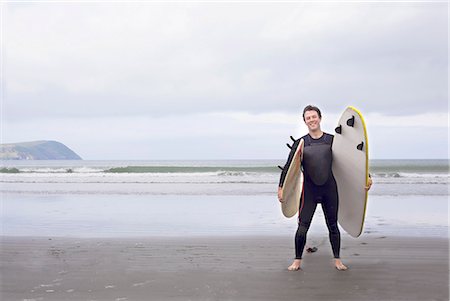 Portrait of man with surfboards on beach Stock Photo - Premium Royalty-Free, Code: 649-07437745