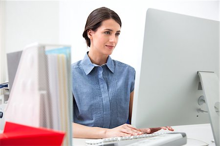 Young woman working on computer Stock Photo - Premium Royalty-Free, Code: 649-07437769