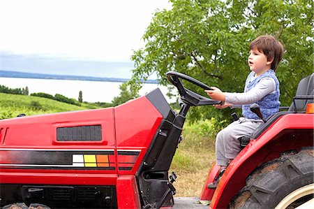 simsearch:695-05768235,k - Male toddler pretending to drive tractor in garden Stock Photo - Premium Royalty-Free, Code: 649-07437843