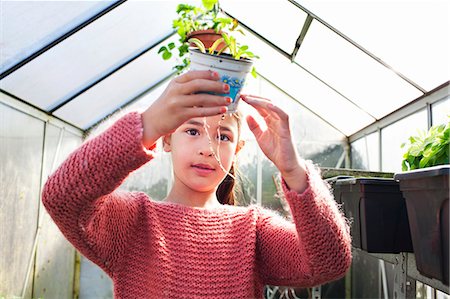 scientific - Girl holding plant pot, looking at roots Stock Photo - Premium Royalty-Free, Code: 649-07437863