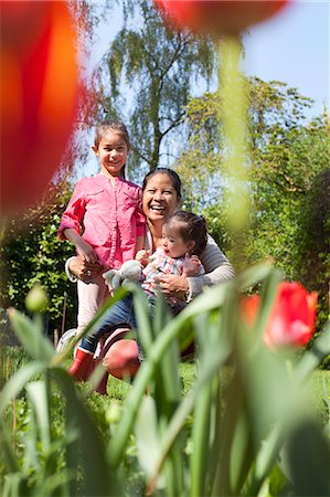 flower for mom asian - Mother with daughters in garden Stock Photo - Premium Royalty-Free, Code: 649-07437872