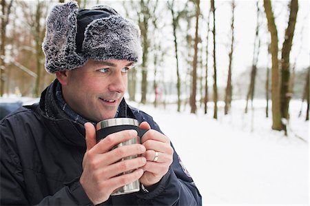 Mature man having hot drink outside in winter Stock Photo - Premium Royalty-Free, Code: 649-07437963