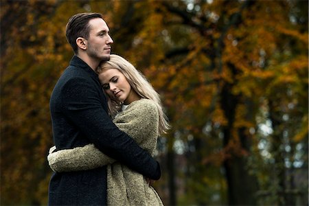 photos of blonde woman with black man - Young couple hugging in woods Stock Photo - Premium Royalty-Free, Code: 649-07520105