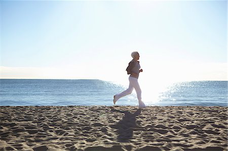 running on sand images - Mature woman jogging on beach Stock Photo - Premium Royalty-Free, Code: 649-07520132