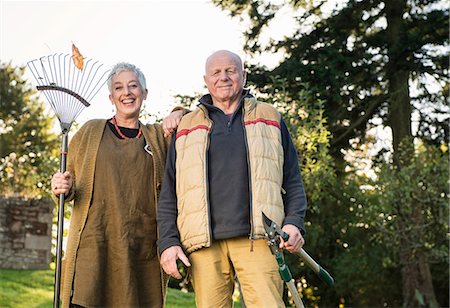 Senior couple holding rake and pruner Stock Photo - Premium Royalty-Free, Code: 649-07520199