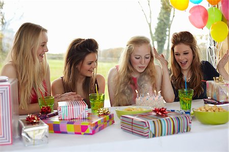 simsearch:649-07520254,k - Teenage girl blowing out birthday candles with friends Stock Photo - Premium Royalty-Free, Code: 649-07520248