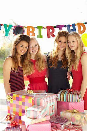 Teenage girl and friends with birthday gifts Stock Photo - Premium Royalty-Free, Code: 649-07520252