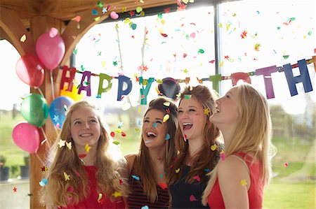 Four teenage girls enjoying confetti at birthday party Stock Photo - Premium Royalty-Free, Code: 649-07520283