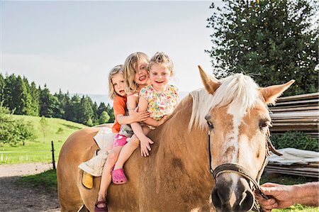 simsearch:649-07520254,k - Three young girls sitting on palomino horse Stock Photo - Premium Royalty-Free, Code: 649-07520341