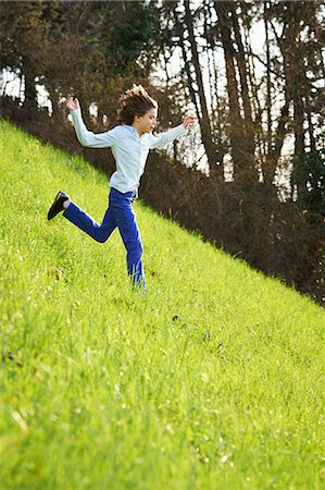 simsearch:649-07596731,k - Young boy running down steep grassy field Stock Photo - Premium Royalty-Free, Code: 649-07520759