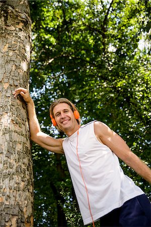 simsearch:693-07672615,k - Male runner stretching in woods Stock Photo - Premium Royalty-Free, Code: 649-07520876