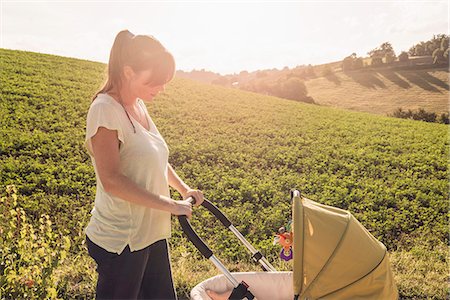 stroll - Mother strolling in countryside pushing baby pram Stock Photo - Premium Royalty-Free, Code: 649-07559771