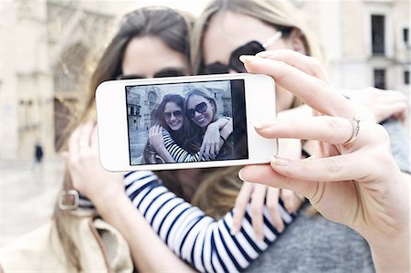 Two young female friends taking a self portrait, Valencia, Spain Stock Photo - Premium Royalty-Free, Code: 649-07560096