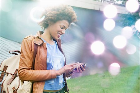 Glowing lights and young woman using smartphone Photographie de stock - Premium Libres de Droits, Code: 649-07560154