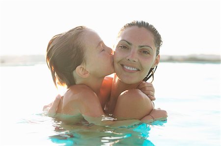 pool child - Portrait of mother and son in outdoor swimming pool, son kissing mother Stock Photo - Premium Royalty-Free, Code: 649-07560297